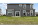Rear view of a two-story house with gray siding and a small patio at 4973 Amber Crest Dr, Brownsburg, IN 46112