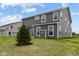 Rear view of a two-story house with gray siding and a small patio at 4973 Amber Crest Dr, Brownsburg, IN 46112