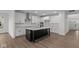 Modern kitchen with white cabinets, granite countertops, and a large island at 4973 Amber Crest Dr, Brownsburg, IN 46112