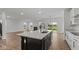 Modern kitchen with white cabinets, granite countertops, and a large island at 4973 Amber Crest Dr, Brownsburg, IN 46112