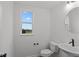 Small powder room with white sink, toilet, and a window offering natural light at 4973 Amber Crest Dr, Brownsburg, IN 46112