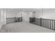 Upstairs hall with gray carpeting, black railings, and a chandelier at 4973 Amber Crest Dr, Brownsburg, IN 46112