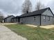 Ranch home with gray brick exterior, new landscaping, and detached garage at 6902 Rodebaugh Rd, Indianapolis, IN 46268