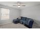 Cozy bedroom with a blue sectional sofa and a window with blinds at 10797 Walden Ln, Brownsburg, IN 46112
