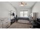 Cozy bedroom with a dresser, a bed, and a workspace at 10797 Walden Ln, Brownsburg, IN 46112