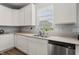 Kitchen with white cabinets, double sink, and modern appliances at 10797 Walden Ln, Brownsburg, IN 46112