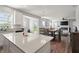 Open concept kitchen with island and views into the living room at 10797 Walden Ln, Brownsburg, IN 46112