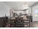 Bright kitchen featuring a large wooden dining table and white cabinets at 10797 Walden Ln, Brownsburg, IN 46112