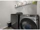 Laundry room with washer, dryer, and shelving for storage at 10797 Walden Ln, Brownsburg, IN 46112