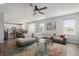 Open concept living room with sectional sofa, large windows, and kitchen views at 10797 Walden Ln, Brownsburg, IN 46112