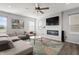 Living room featuring a sectional sofa, fireplace, and large TV at 10797 Walden Ln, Brownsburg, IN 46112