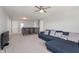 Open loft with carpeted floor, sectional sofa, and ceiling fan at 10797 Walden Ln, Brownsburg, IN 46112