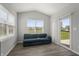 Sunroom with a comfortable couch and sliding glass door to backyard at 10797 Walden Ln, Brownsburg, IN 46112