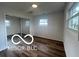 Well-lit bedroom with mirrored closet doors and wood-look floors at 11 S 1050 W, Jamestown, IN 46147