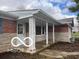 Brick ranch house with attached garage and landscaped yard at 11 S 1050 W, Jamestown, IN 46147