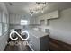 Updated kitchen with white cabinets, gray island, and hardwood floors at 11 S 1050 W, Jamestown, IN 46147