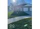 Gray two-bedroom ranch with attached garage and grassy yard at 1492 Coen Ct, Columbus, IN 47201
