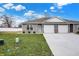 Newly constructed home with a two-car garage and landscaped lawn at 1492 Coen Ct, Columbus, IN 47201
