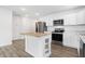 Open kitchen with stainless steel appliances and white cabinetry at 1492 Coen Ct, Columbus, IN 47201