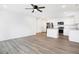 Open concept kitchen and living area with stainless steel appliances and vinyl flooring at 1492 Coen Ct, Columbus, IN 47201