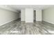 Finished basement with grey plank flooring and access to bathroom at 408 N Sherwood Dr, Muncie, IN 47304