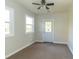 Bedroom with carpet, two windows, and exterior access at 408 N Sherwood Dr, Muncie, IN 47304