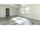Simple bedroom with gray vinyl plank flooring and large window at 408 N Sherwood Dr, Muncie, IN 47304