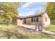 Brick ranch house with a concrete patio and driveway at 408 N Sherwood Dr, Muncie, IN 47304