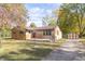 Brick ranch home with a large front yard and mature trees at 408 N Sherwood Dr, Muncie, IN 47304