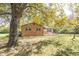 Brick ranch home with a large front yard and mature trees at 408 N Sherwood Dr, Muncie, IN 47304