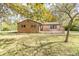 Brick ranch home with a large front yard and mature trees at 408 N Sherwood Dr, Muncie, IN 47304