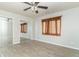 Bedroom with ceiling fan, mirrored closet doors, window with sheer curtains, and hardwood floors at 408 N Sherwood Dr, Muncie, IN 47304