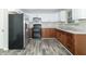 Modern kitchen with stainless steel appliances and wood cabinets at 408 N Sherwood Dr, Muncie, IN 47304