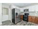 Modern kitchen with stainless steel appliances and wood cabinets at 408 N Sherwood Dr, Muncie, IN 47304