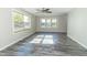 Bright living room with gray vinyl plank flooring and ceiling fan at 408 N Sherwood Dr, Muncie, IN 47304