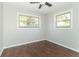 Bedroom with ceiling fan and hardwood floors, featuring two windows at 408 N Sherwood Dr, Muncie, IN 47304
