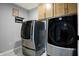 Laundry room features a washer and dryer, cabinets, and tile floor at 6427 Nicoson Way, Indianapolis, IN 46259