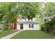 White house with black shutters and green lawn at 1306 S Talbott St, Indianapolis, IN 46225