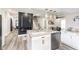 Open concept kitchen with an island and a view into living room at 1306 S Talbott St, Indianapolis, IN 46225