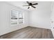 Bright bedroom with ceiling fan and wood-look flooring at 1432 Coen Ct, Columbus, IN 47201