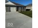 Gray ranch home with white garage door and landscaping at 1432 Coen Ct, Columbus, IN 47201