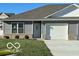 Gray ranch home with white garage door and landscaping at 1432 Coen Ct, Columbus, IN 47201