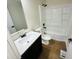 Updated bathroom with white vanity and tub/shower combo at 1714 S Goodlet Ave, Indianapolis, IN 46241