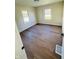 Spacious bedroom featuring hardwood floors and two windows at 1714 S Goodlet Ave, Indianapolis, IN 46241