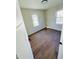Well-lit bedroom, hardwood floors, and two windows at 1714 S Goodlet Ave, Indianapolis, IN 46241