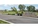 Stone entrance sign to the Quail West community, showcasing landscaping at 243 Hunters Ridge Dr, Danville, IN 46122