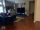 Living room with hardwood floors and a large TV at 4112 Eagle Cove E Dr, Indianapolis, IN 46254