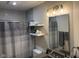 Bathroom with gray subway tile, floating shelves, and updated vanity at 4204 W Palomino Ct, Muncie, IN 47304