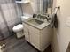 Modern bathroom with gray speckled vanity, and dark gray flooring at 4204 W Palomino Ct, Muncie, IN 47304