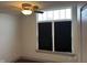 Bright bedroom with large window, ceiling fan, and dark blinds at 4204 W Palomino Ct, Muncie, IN 47304